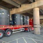 trucks under bridge with pipe